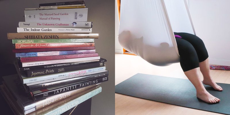 a stack of art books books and someone reading in an aerial hammock